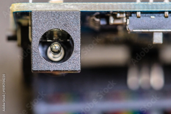 Fototapeta Close-up of a power connector port on a circuit board, highlighting electronic design