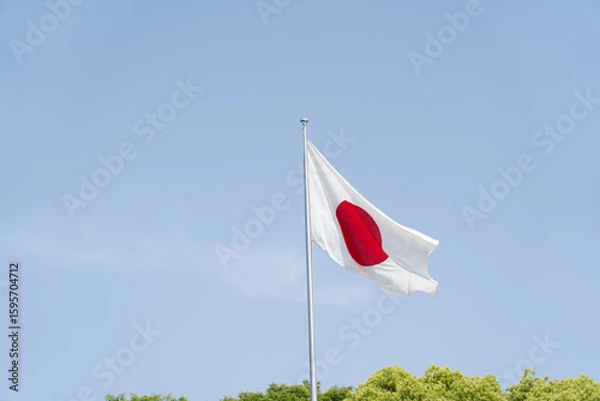 Obraz Japanese flag waving in wind against clear blue sky background