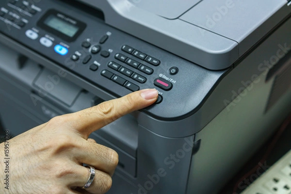 Obraz Finger pressing start button of fax machine , office equipment
