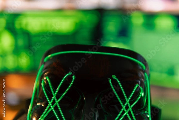 Fototapeta In a dimly lit cyber lair, a glowing hacker mask watches over a desk as encrypted code streams across three glowing monitors — the hack has already begun.
