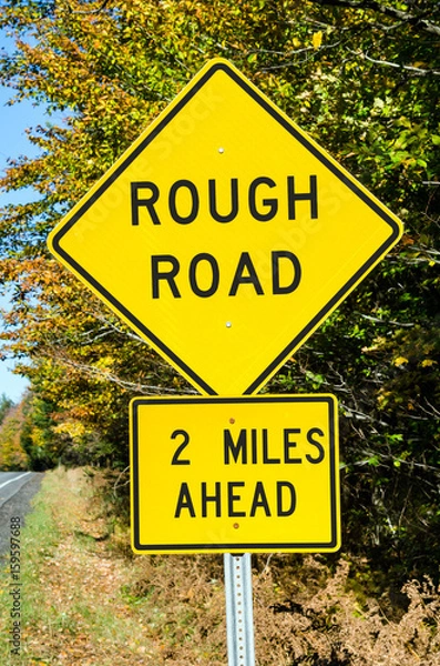 Obraz Rough Road Ahead. Warning Traffic Sign on a Mountain Road