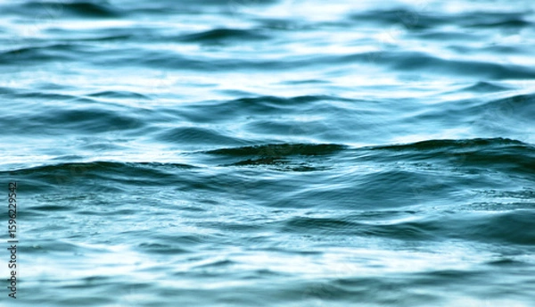 Fototapeta Soft ripples on the surface of beautiful blue waters