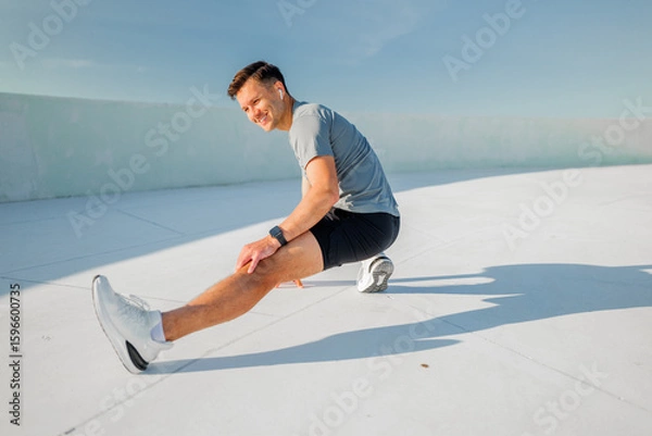 Fototapeta Stretching routine on a bright rooftop during a sunny morning workout session