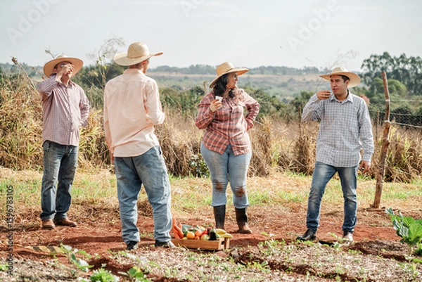 Fototapeta Group of Farmers Enjoying Refreshments in the Field