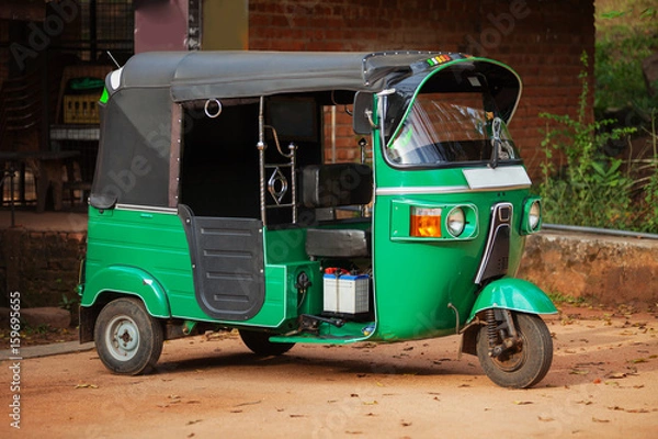Fototapeta Small car with three wheels. Asian taxi tuk-tuk