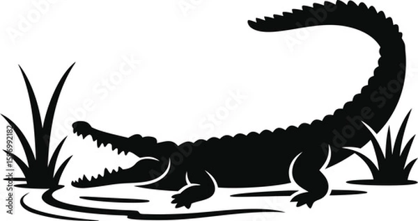 Fototapeta Silhouette of a fierce alligator emerging from murky swamp water with reeds