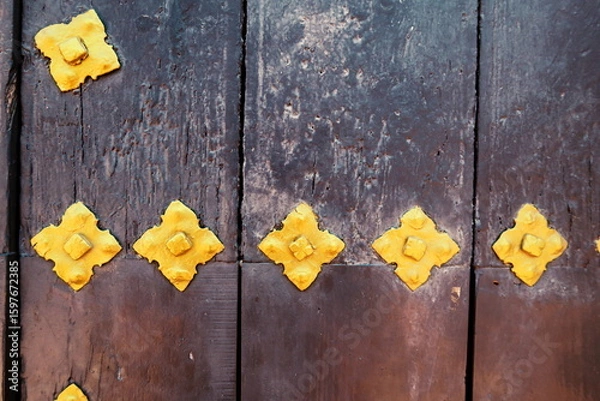 Fototapeta Ferrures dorées sur porte ancienne en bois.