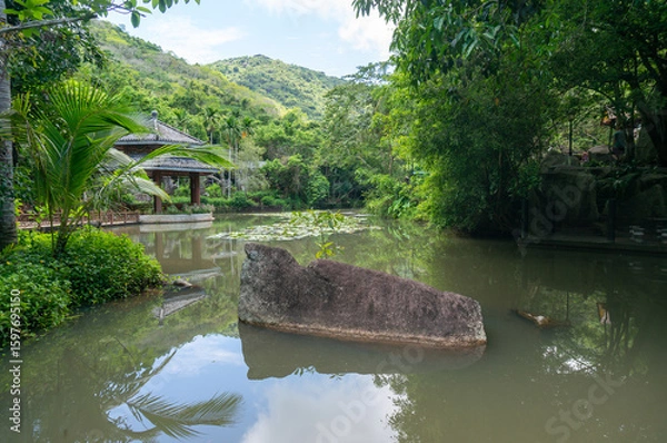 Fototapeta Beautiful view of the Asian-style pavilion on the water in the park.