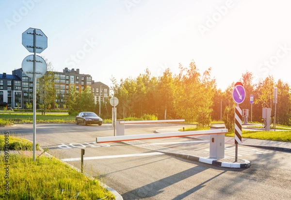 Fototapeta Automatic car barrier in Private urbanization residential area. Car barrier in front yard in Condominium. Barrier Gate on parking lot. Barrier for entry and exit to parking lot for residents of area.