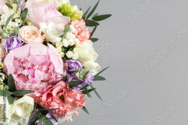 Fototapeta luxurious and elegant bouquet of roses and Other flowers. Composition colors on gray background. Copy space.