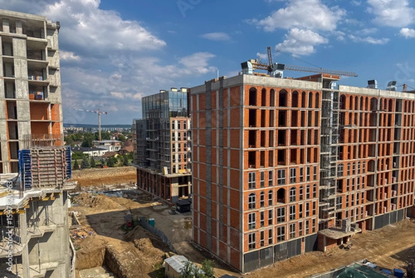 Fototapeta construction site shows multiple high-rise buildings in various stages of development