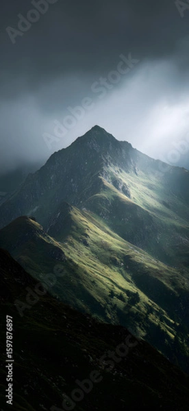 Fototapeta Towering Mountain Wrapped in Clouds

