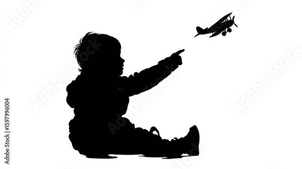 Fototapeta Silhouette of a child pointing upwards at a toy airplane in flight, set against a white backdrop