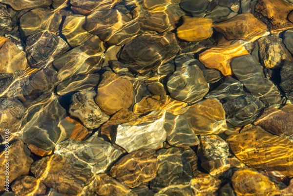 Fototapeta Berg, Sweden Pebbles and rocks on the shore of a pristine lake.