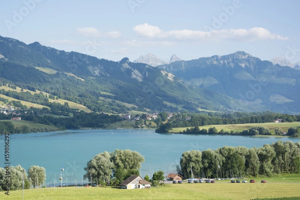 Obraz A View of Lac de la Gruyère (Lake of Gruyère) in Switzerland on a Summer Day