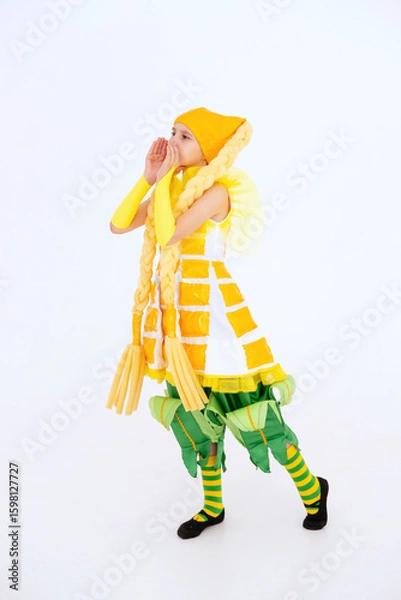 Obraz Call to action. Sale. Cheerful girl having fun, dancing and laughing on light background in yellow corn costume with funny facial expression in empty space. vertical.