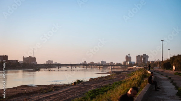 Obraz Evening view of the Tigris River with people relaxing along the waterfront in Baghdad Iraq