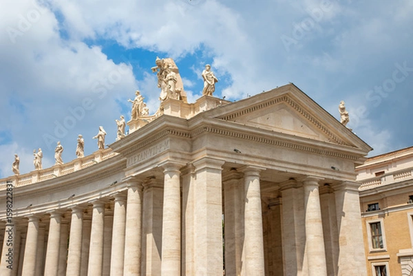 Fototapeta Colonnade of St. Peter’s Square with blue sky with clouds on the background. Vatican. Italy. Horizontally. 