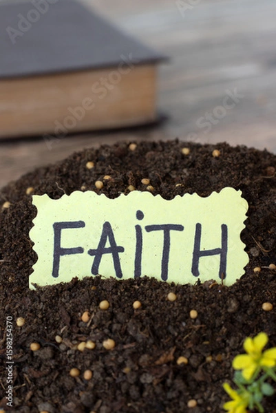 Obraz Faith handwritten text in soil with mustard seeds and holy bible in the background. Close-up. Trust and belief in God Jesus Christ, biblical concept.