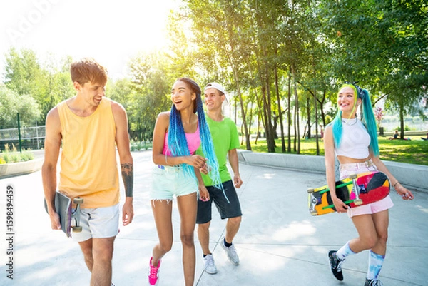 Fototapeta Group of professional skaters teens at the skatepark