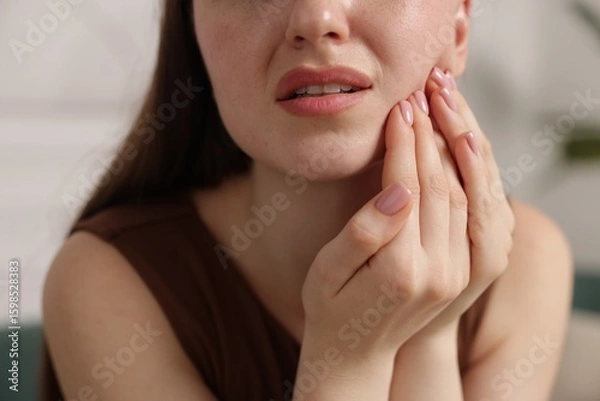 Fototapeta Woman suffering from toothache at home, closeup