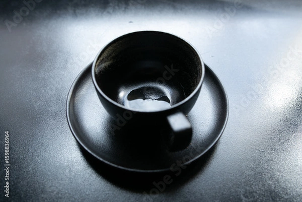 Obraz black cup on a black windowsill