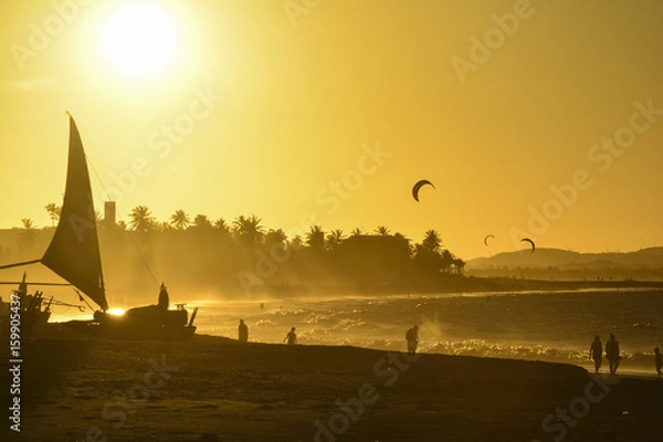 Fototapeta Sunset at Cumbuco Beach. Kite surfers on the sea, Ceara State, Brazil