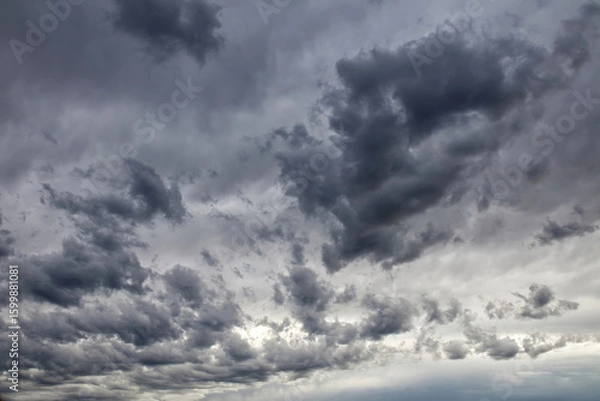 Obraz Dramatic dark and ominous storm clouds filling the sky on an overcast day.