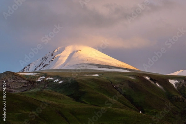 Fototapeta Palandoken mountain covered with snow in fall with green lands