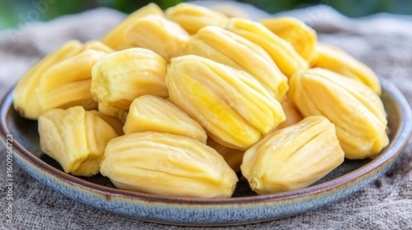 Fototapeta Fresh and Ripe Jackfruit Segments on Rustic Plate Background