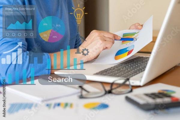 Fototapeta Businesswoman analyzing financial charts and market trends on a laptop, utilizing data analysis tools for strategic decision-making and company growth