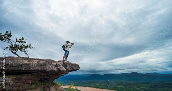 Fototapeta Tourists watch the atmosphere, sky and clouds above the Mekong mountain at Pha Chanadai. Ubon Ratchathani, Thailand