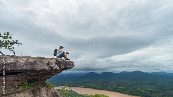 Fototapeta Tourists watch the atmosphere, sky and clouds above the Mekong mountain at Pha Chanadai. Ubon Ratchathani, Thailand