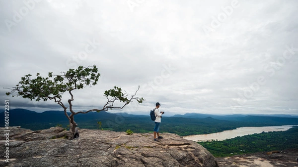 Fototapeta Tourists watch the atmosphere, sky and clouds above the Mekong mountain at Pha Chanadai. Ubon Ratchathani, Thailand