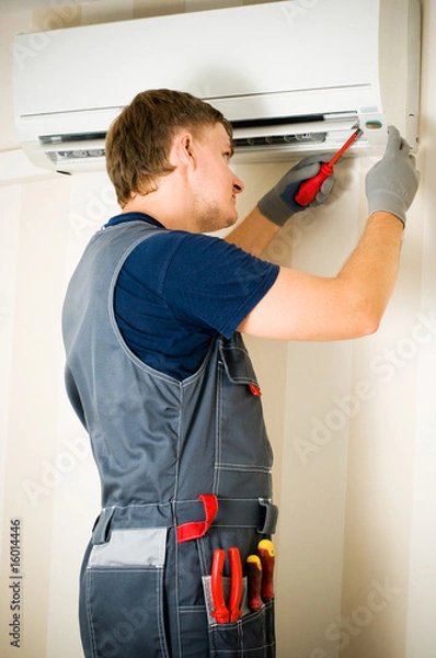 Obraz man repair air-conditioner