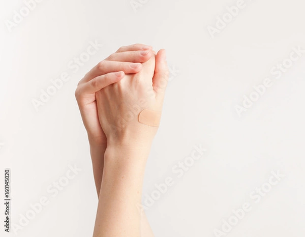 Obraz Sticking plaster on hand on white background