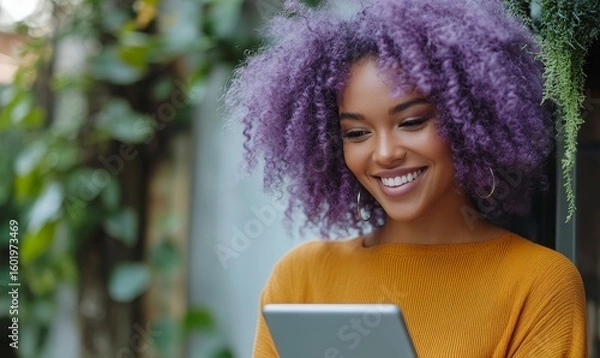 Fototapeta Happy mixed-race Black woman with purple curly hair smiling at a smart tablet device. Young African American woman staying connected with friends on social media with wifi, Generative AI