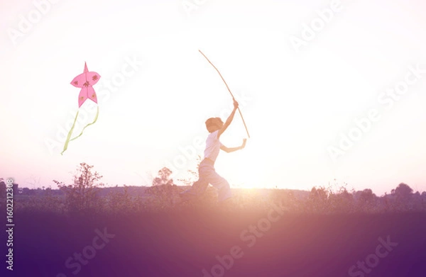 Obraz Child flying a multicolored kite outside