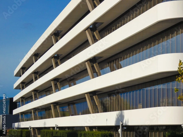 Fototapeta Perspective view of a recent corporate building with a modern design, many windows, and a white facade near Geneva, Switzerland