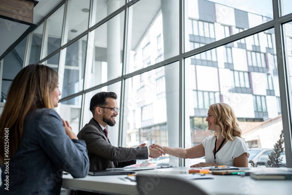 Obraz Business people shaking hands after successful meeting in office