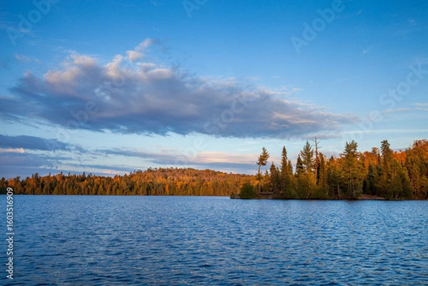 Obraz Blue trout lake with trees and hills in autumn color at sunset in northern Minnesota