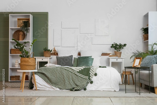 Fototapeta Wicker baskets with houseplants  on table in interior of light bedroom