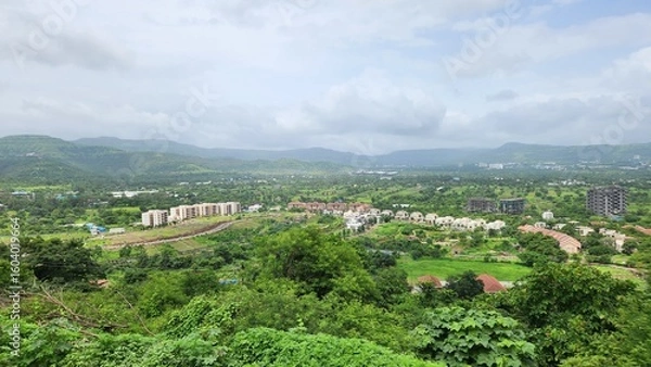 Fototapeta Countryside landscape view with mountains and greenery