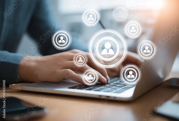 Fototapeta Person typing on a laptop with floating user profile icons, symbolizing online networking or social media interaction.