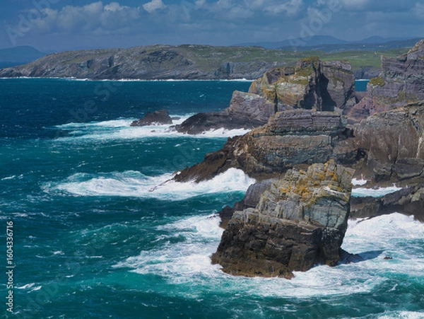 Fototapeta Stunning view of rugged cliffs against the crashing Atlantic Ocean at Mizen Head, Ireland, capturing natural beauty and power.