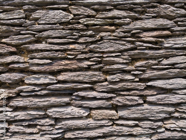 Fototapeta Close-up of a rustic stone wall, capturing the intricate textures and craftsmanship, typical of Irish architecture.
