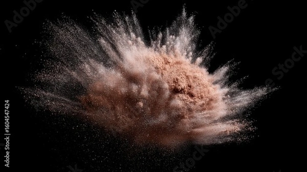 Fototapeta Dynamic brown powder suspended in mid-air against a deep black background, capturing movement.