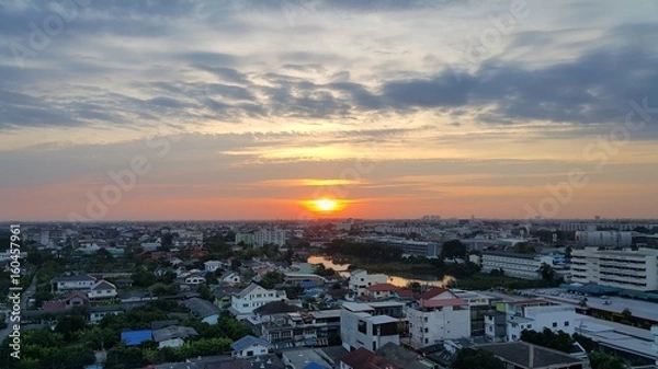 Fototapeta Another day sunrise and the city skyline with the dark cloud.