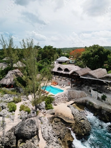 Fototapeta Aerial drone view of the dramatic cliffs of Negril, Jamaica, with turquoise Caribbean waters, lush vegetation, and stunning sunsets, an unforgettable tropical paradise on the island’s west coast

