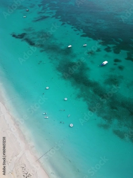 Fototapeta Aerial drone view of Seven Mile Beach in Negril, Jamaica, revealing crystal-clear Caribbean waters, white sandy shores and vibrant life along one of the most iconic beaches in the Caribbean